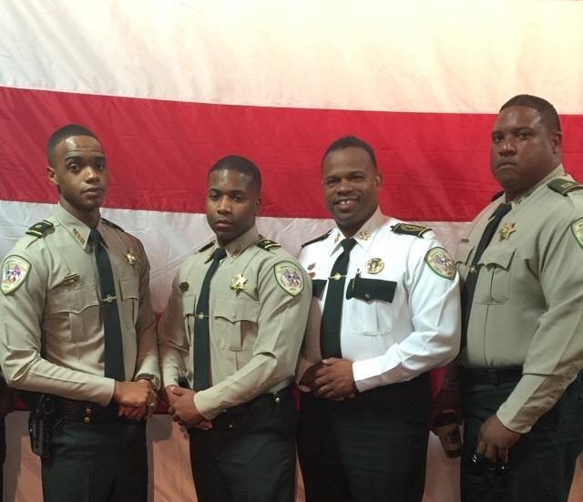 Deputies Brown and James were congratulated in front of the USA Flag